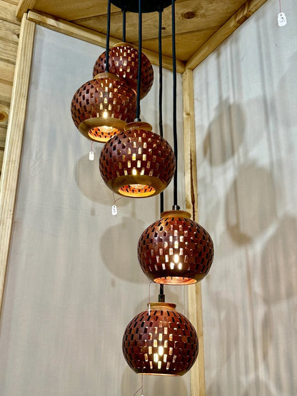 Five-globe handmade bloodwood and canarywood pendant chandelier in a cascading spiral arrangement on display