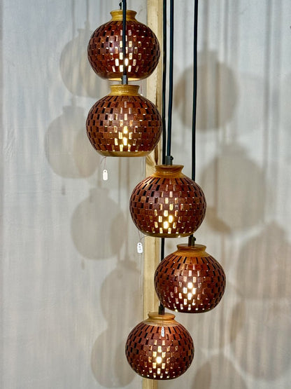 Five-globe handmade bloodwood and canarywood pendant chandelier cascading at staggered heights on display